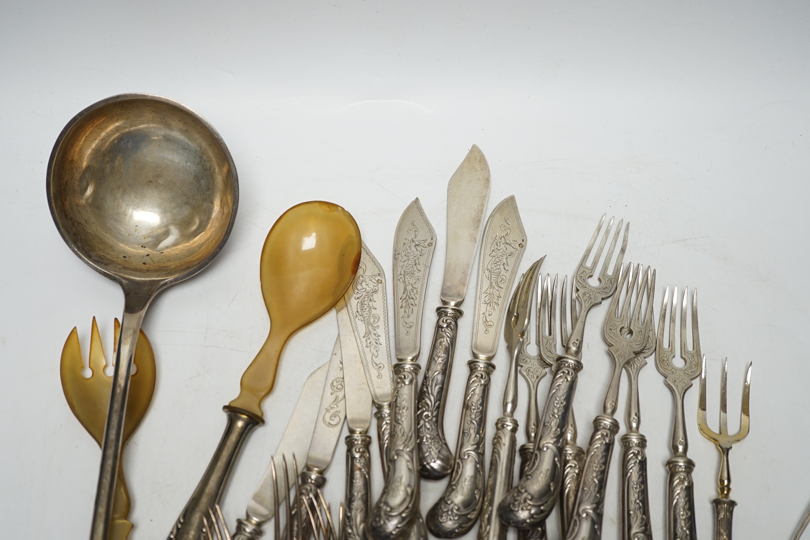 Six Victorian silver dessert forks by George Adams, London, 1880, with Meissen handles, 17.5cm(a.f.), eight 800 standard sorbet spoons, seven pairs of Austro-Hungarian white metal fish eaters, five other continental item